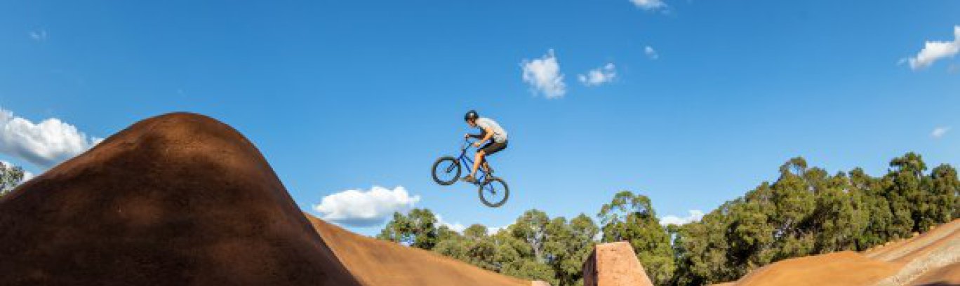 A cyclist jumping over a bike track