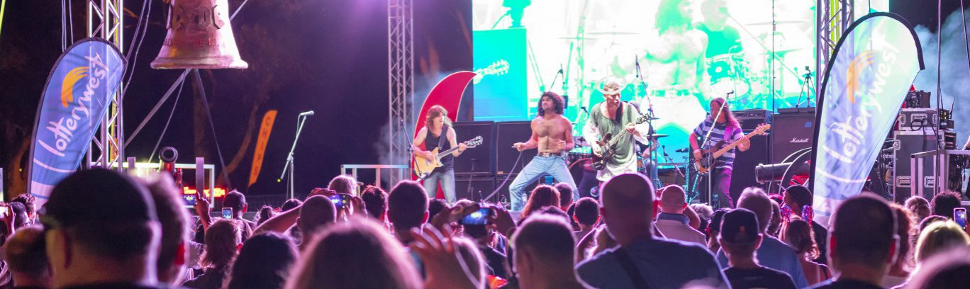 AC/DC/ tribute band singing on stage at Australia Day