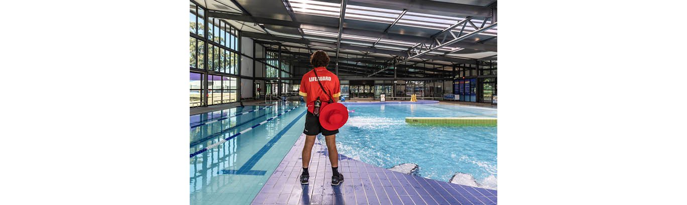 Lifeguard looking at swimming pools