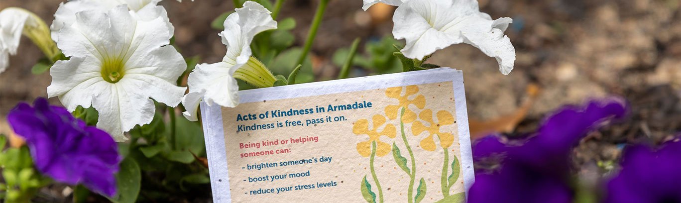 kindness card planted in garden
