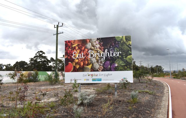 Image of billboard with fruit and vegetables and title 'Eat Brighter'